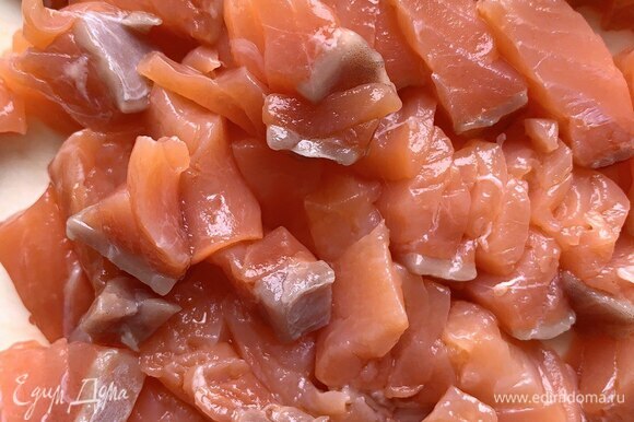 Слабосоленую красную рыбу разрежьте на кусочки 2 х 2 см. Разрезайте поперек волокон — так легче достать косточки.