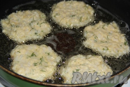 В сковороду налить растительное масло, разогреть. Выкладывать на сковороду по одной столовой ложке рисово-сырной массы, формируя круглые оладьи.
