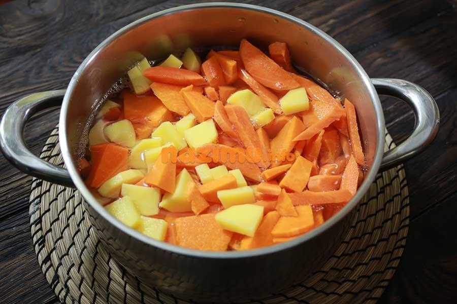 нарезанные крупными брусочками картошка и морковь в кастрюле с водой